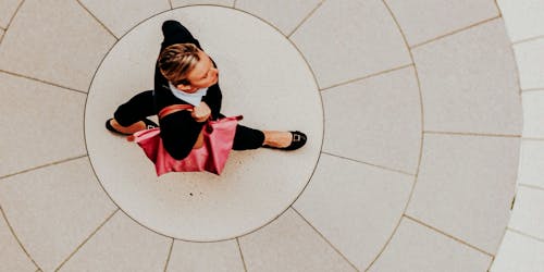 Birds eyeview of woman walking over circular paving