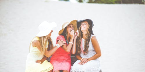 Three women, chatting on a bench