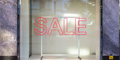 A sale sign in an empty window