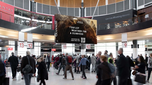 Guinness billboard in crowded train station