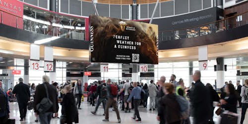 Guinness billboard in crowded train station