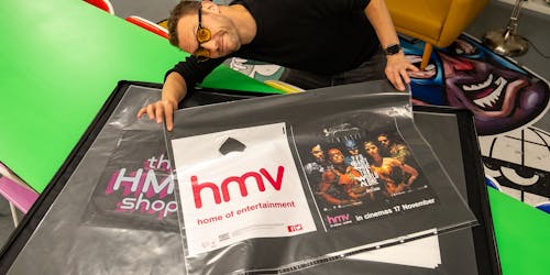 Lee Bofkin shows off an HMV poster from Global Street Art's collection