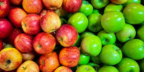 A number of red and green apples side by side