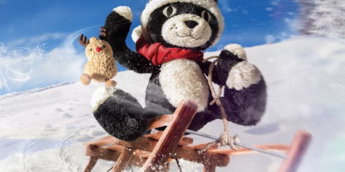 Jellycat teddy riding a sleigh in snow 