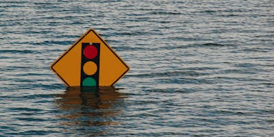 A road sign being swallowed by a rising tide