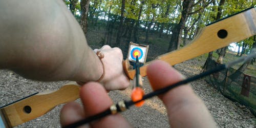 An archery arrow points at a target