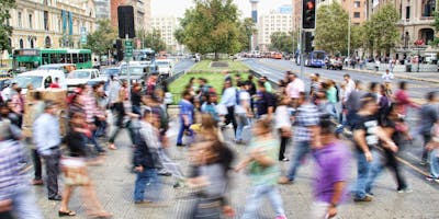 A blur of people walking across an intersection