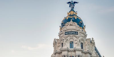 Photograph of a tower with cupola against a blue sky