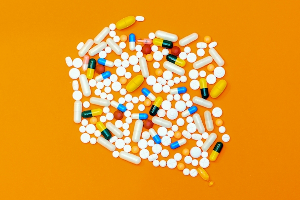 Pills arranged attractively on an orange background