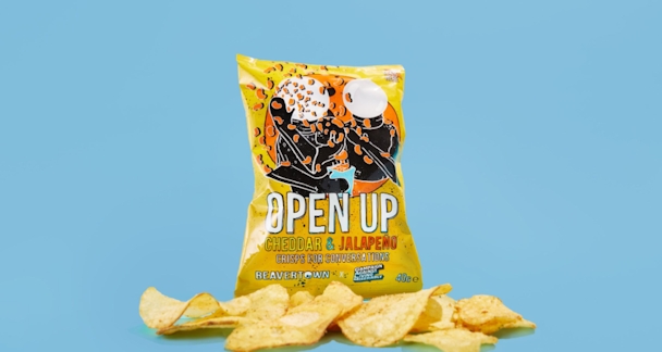 A packet of the Beavertown open up crisps with a handful of crisps placed in front