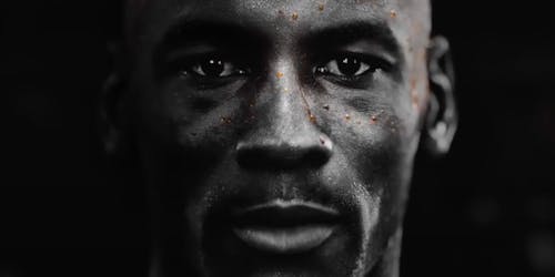 A still from Gatorade's advert featuring a close-up of a man's face with beads of orange sweat on it