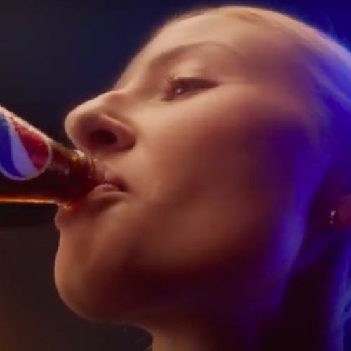 Footballer Leah Williamson drinks from a bottle of Pepsi, in an ad for the drinks company