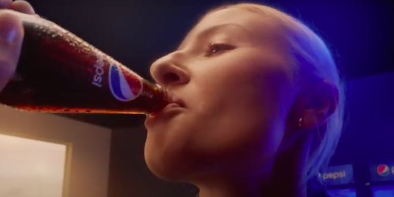 Footballer Leah Williamson drinks from a bottle of Pepsi, in an ad for the drinks company