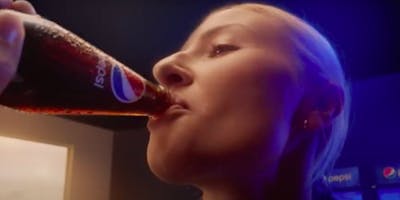 Footballer Leah Williamson drinks from a bottle of Pepsi, in an ad for the drinks company