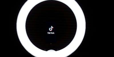 The TikTok logo in a ring light