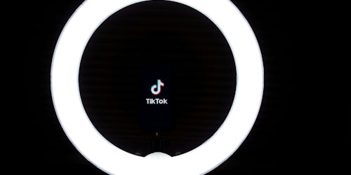 A light ring frames the TikTok logo