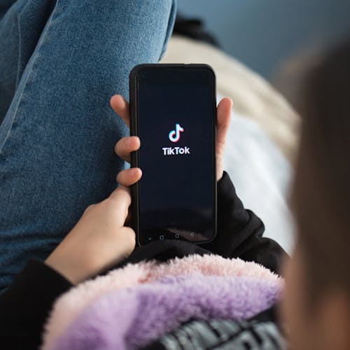 Kid using TikTok on mobile device