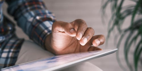 man looks at data  on his ipad