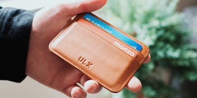 A wallet with two cards in it, one Monzo and one Barclays 