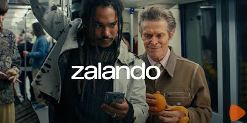 Actor William Dafoe peeling an orange on a metro with the Zalando banner 