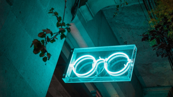 A neon sign of a pair of glasses