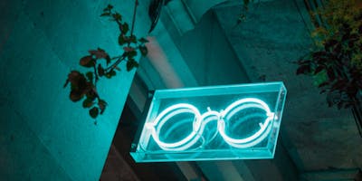 A neon sign of a pair of glasses